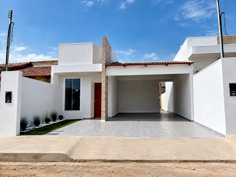 Fachada da casa de 2 quartos no Jardim Tropical, com jardim na frente e garagem coberta